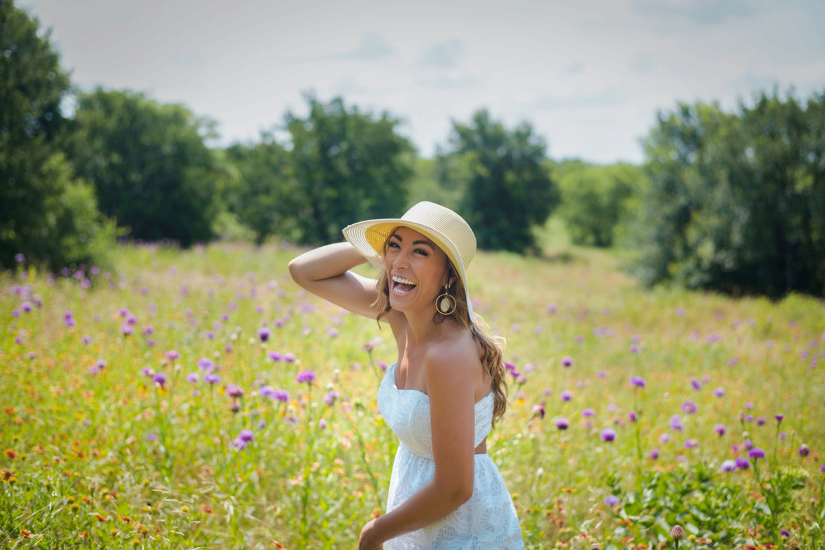 Woman in white dress with bright smile